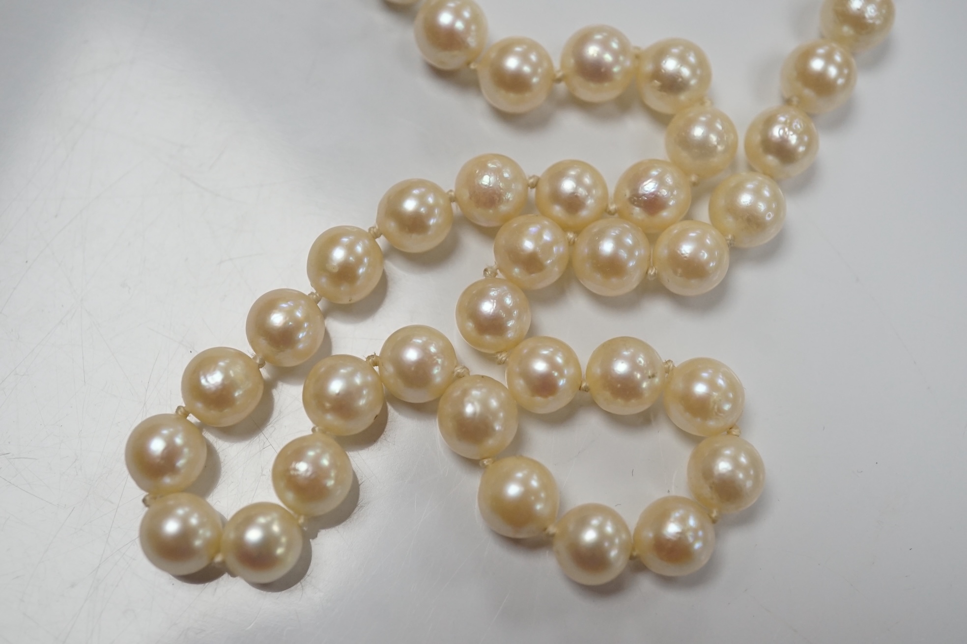 Two modern single strand cultured pearl necklaces, one with cultured pearl and gem set 18ct gold clasp, 48cm, the other with cultured pearl cluster set 9ct gold clasp, 54cm. Condition - fair to good.